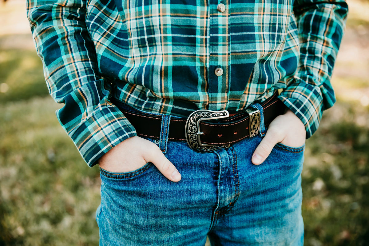 Rancher chocolate oiled water buffalo belt with ornate silver Western buckle, worn