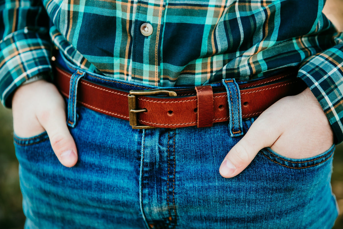 Man wearing Robert water buffalo belt with antiqued brass roller buckle