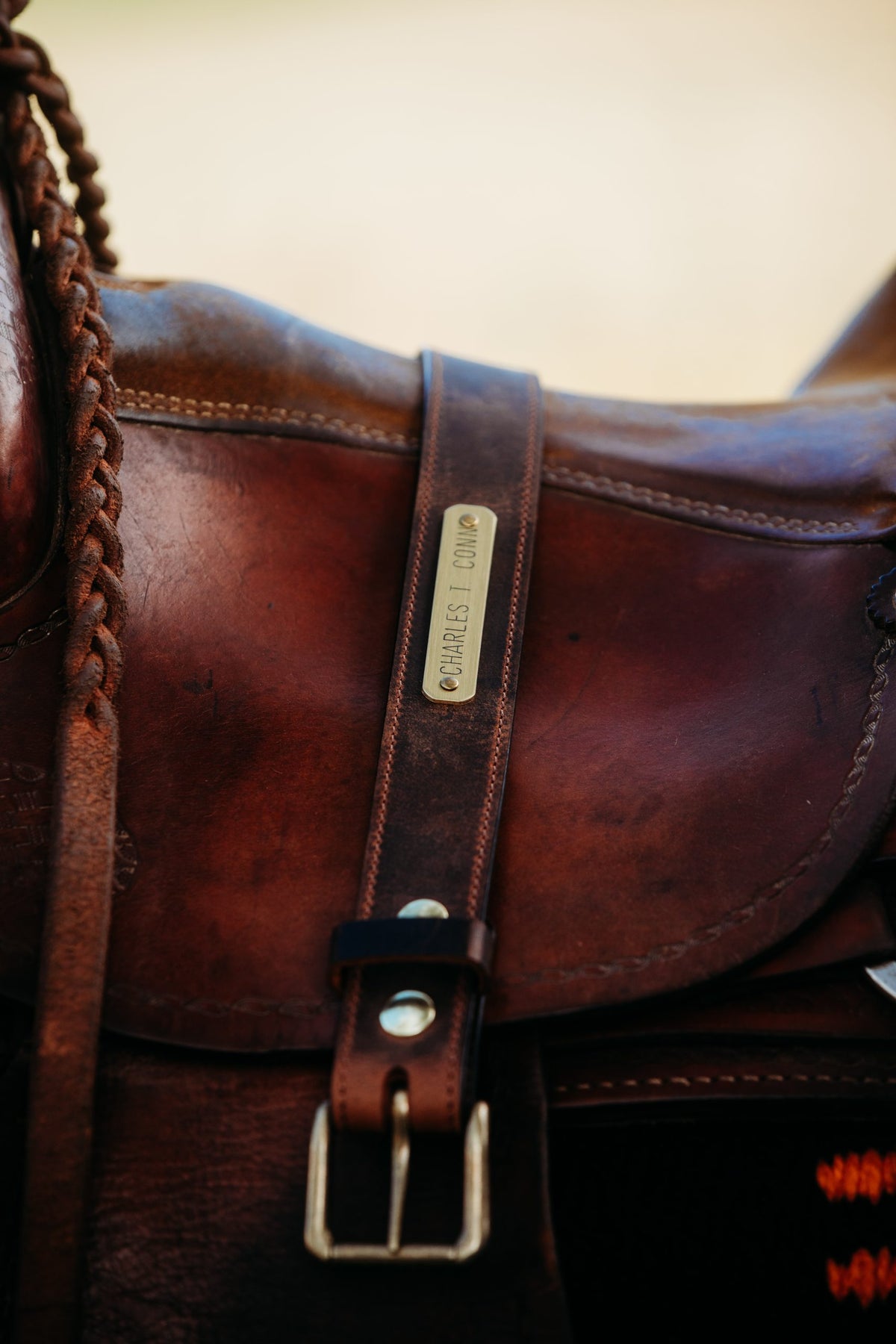 Brass nameplate strap in water buffalo leather on leather satchel