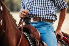 Reagan embossed water buffalo leather belt worn with jeans