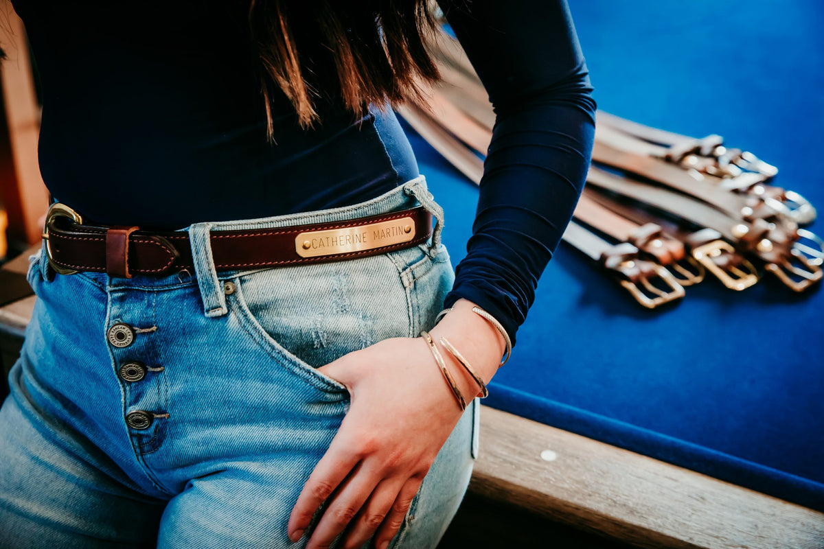 Woman wearing 1-inch Rich Brown bridle leather nameplate belt with jeans