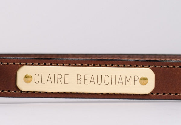 Rich Brown bridle leather belt nameplate close-up with brass rivets