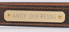 Brass nameplate close-up on distressed brown water buffalo leather belt