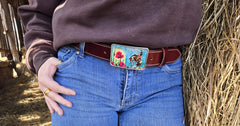 Woman wearing Bucking Bronc crimson water buffalo belt with jeans