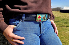Woman wearing Bucking Bronc blue water buffalo belt with jeans