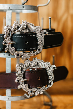 Brooke belts in black and brown water buffalo with horse head buckles