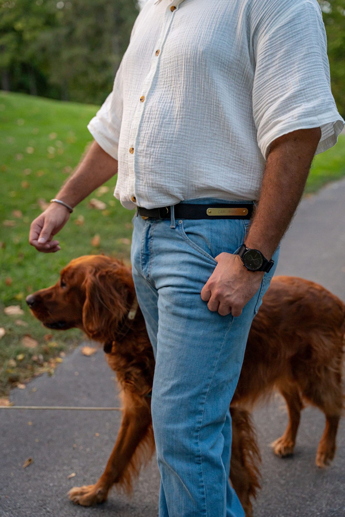 Man wearing black water buffalo nameplate belt with solid brass plate