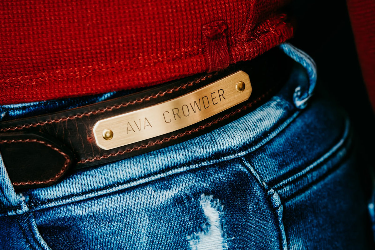 Distressed brown water buffalo nameplate belt, engraved brass plate close-up