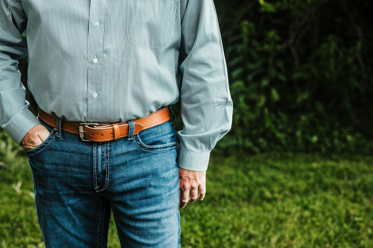 The Saturday harness leather belt in tan worn with jeans