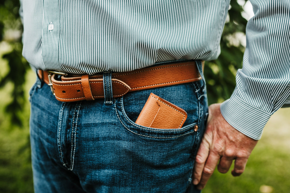 Man carrying buck brown harness leather front pocket wallet in jeans pocket
