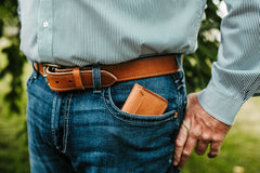 Man carrying buck brown harness leather front pocket wallet in jeans pocket