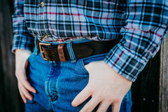 Man wearing Waylon distressed water buffalo belt with brass roller buckle