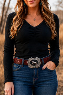 Woman wearing The Bridle Rose embossed leather belt with jeans