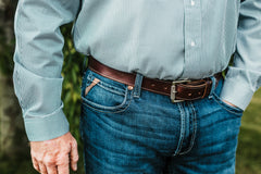 The Friday bridle leather belt in brown worn with jeans