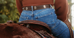 Woman wearing the Claire water buffalo leather belt with jeans