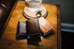 Monogrammed buck brown harness leather wallet in three-wallet lineup