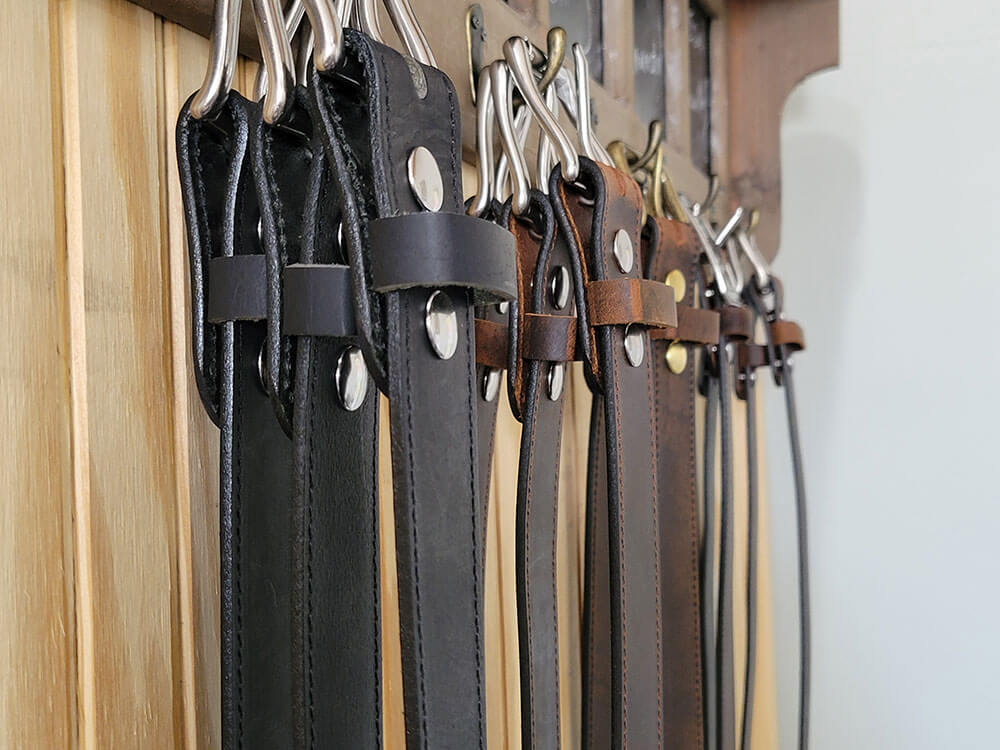 Leather belts hanging in the workshop