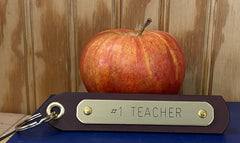Brown leather keytag with engraved #1 Teacher brass nameplate